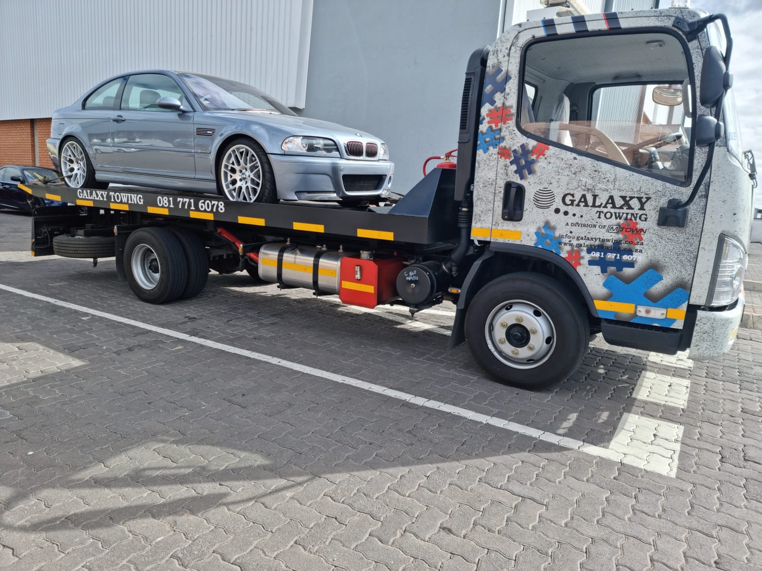 Galaxy Towing flatbed transporting a classic Chevrolet Bel Air