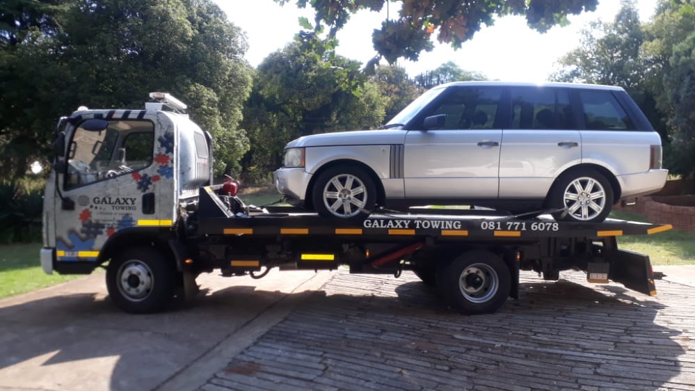 Galaxy Towing moving a Toyota forklift on a flatbed
